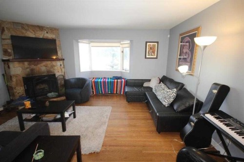 3824 Brantford Drive Nw, Calgary, AB - Indoor Photo Showing Living Room With Fireplace