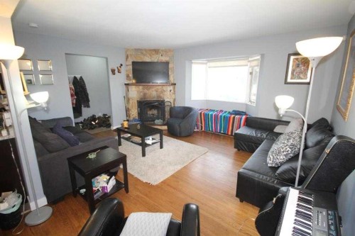 3824 Brantford Drive Nw, Calgary, AB - Indoor Photo Showing Living Room With Fireplace