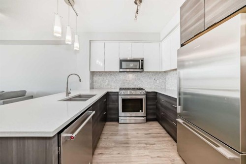3210-95 Burma Star Road Sw, Calgary, AB - Indoor Photo Showing Kitchen With Stainless Steel Kitchen With Double Sink With Upgraded Kitchen