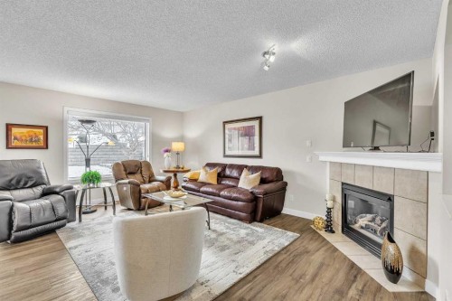 103 Panamount Crescent Nw, Calgary, AB - Indoor Photo Showing Living Room With Fireplace
