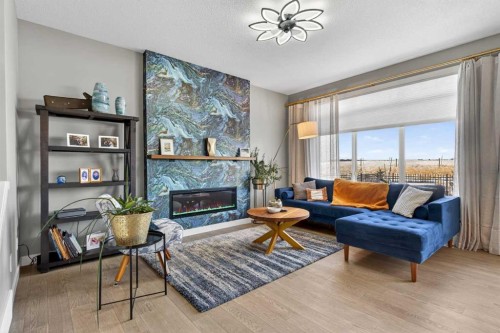 188 Sunrise Common, Cochrane, AB - Indoor Photo Showing Living Room With Fireplace