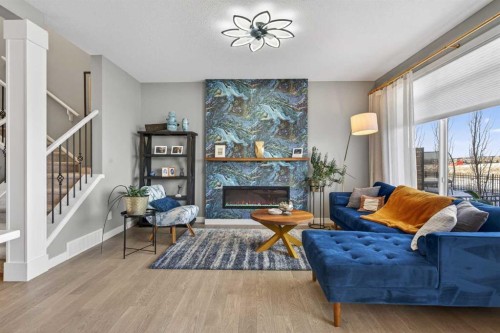 188 Sunrise Common, Cochrane, AB - Indoor Photo Showing Living Room With Fireplace