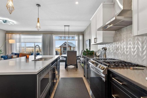188 Sunrise Common, Cochrane, AB - Indoor Photo Showing Kitchen With Double Sink With Upgraded Kitchen