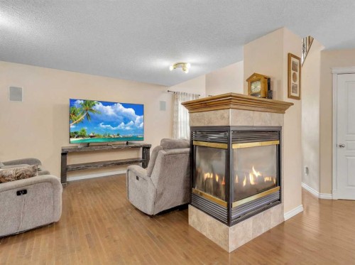 60 Sherwood Way Nw, Calgary, AB - Indoor Photo Showing Living Room With Fireplace