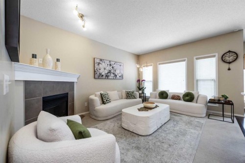 212 Silverado Range Heights Sw, Calgary, AB - Indoor Photo Showing Living Room With Fireplace
