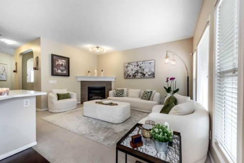 212 Silverado Range Heights Sw, Calgary, AB - Indoor Photo Showing Living Room With Fireplace