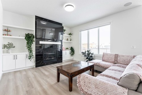 27 Bridges Drive, Langdon, AB - Indoor Photo Showing Living Room With Fireplace