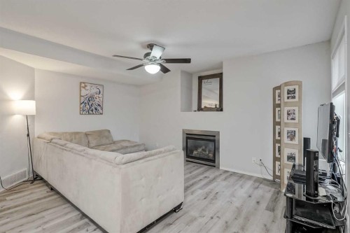 222 Bridleridge Way Sw, Calgary, AB - Indoor Photo Showing Living Room With Fireplace