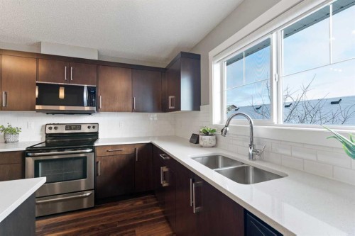 143 Baysprings Terrace, Airdrie, AB - Indoor Photo Showing Kitchen With Double Sink With Upgraded Kitchen