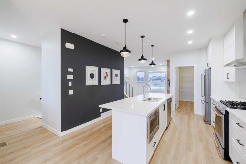 213 Alpine Rush View, Rural Rocky View County, AB - Indoor Photo Showing Kitchen With Double Sink With Upgraded Kitchen