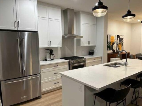 213 Alpine Rush View, Rural Rocky View County, AB - Indoor Photo Showing Kitchen With Stainless Steel Kitchen With Double Sink With Upgraded Kitchen