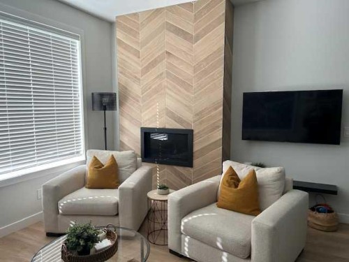 213 Alpine Rush View, Rural Rocky View County, AB - Indoor Photo Showing Living Room With Fireplace