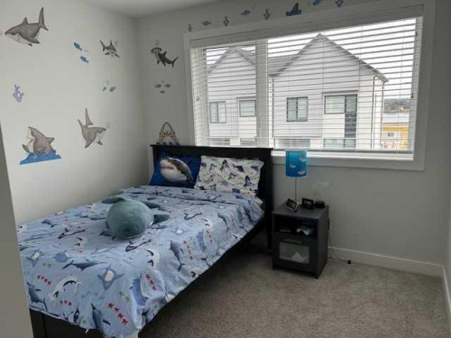 213 Alpine Rush View, Rural Rocky View County, AB - Indoor Photo Showing Bedroom