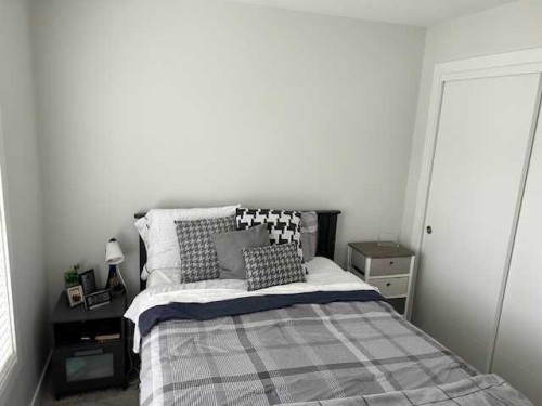 213 Alpine Rush View, Rural Rocky View County, AB - Indoor Photo Showing Bedroom