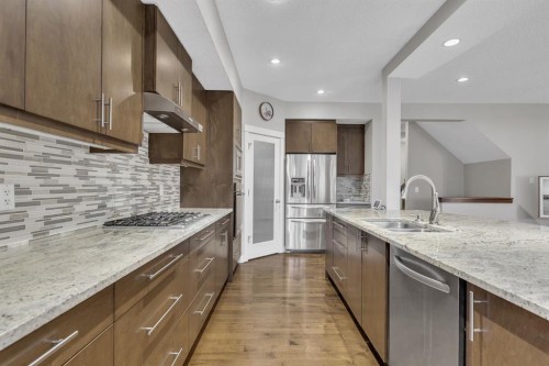 12 Cougar Ridge Manor Sw, Calgary, AB - Indoor Photo Showing Kitchen With Stainless Steel Kitchen With Double Sink With Upgraded Kitchen