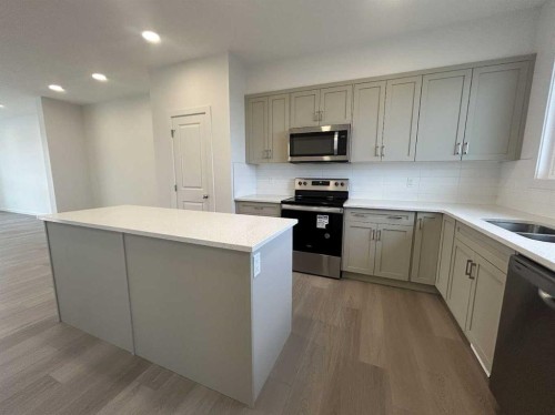 200 Belmont Way Sw, Calgary, AB - Indoor Photo Showing Kitchen With Double Sink