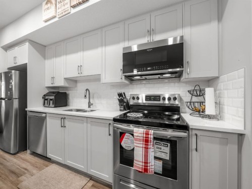 410 Copperstone Manor Se, Calgary, AB - Indoor Photo Showing Kitchen With Stainless Steel Kitchen With Double Sink