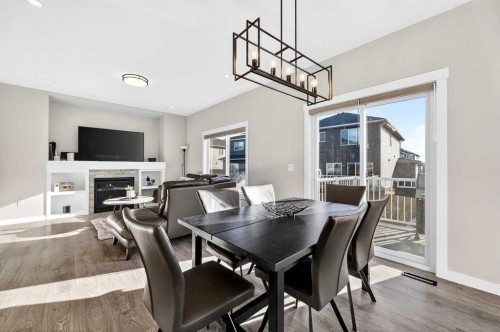 1409 Price Close, Carstairs, AB - Indoor Photo Showing Dining Room With Fireplace