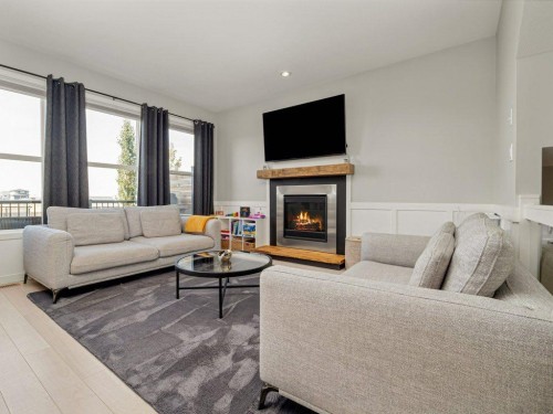 102 Blackwolf Bay North, Lethbridge, AB - Indoor Photo Showing Living Room With Fireplace
