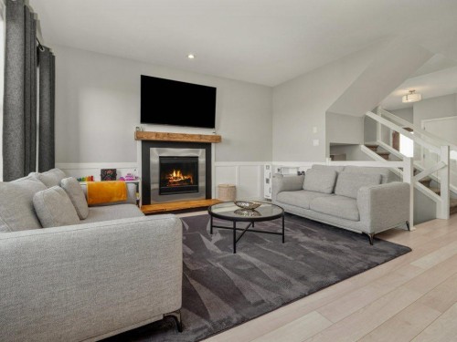 102 Blackwolf Bay North, Lethbridge, AB - Indoor Photo Showing Living Room With Fireplace