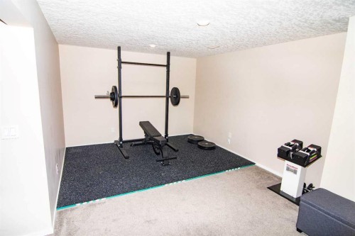 2275 Reunion Street Nw, Airdrie, AB - Indoor Photo Showing Gym Room