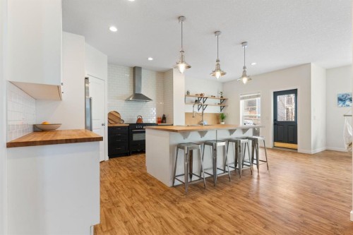 196 Jumping Pound Terrace, Cochrane, AB - Indoor Photo Showing Kitchen With Upgraded Kitchen