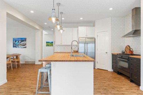 196 Jumping Pound Terrace, Cochrane, AB - Indoor Photo Showing Kitchen With Double Sink With Upgraded Kitchen