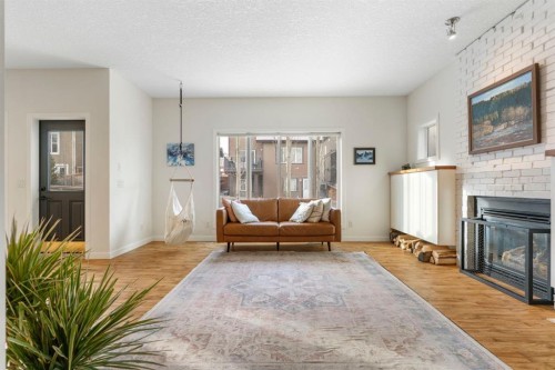 196 Jumping Pound Terrace, Cochrane, AB - Indoor Photo Showing Living Room With Fireplace