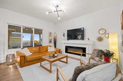 22 Hanson Drive Ne, Langdon, AB - Indoor Photo Showing Living Room With Fireplace