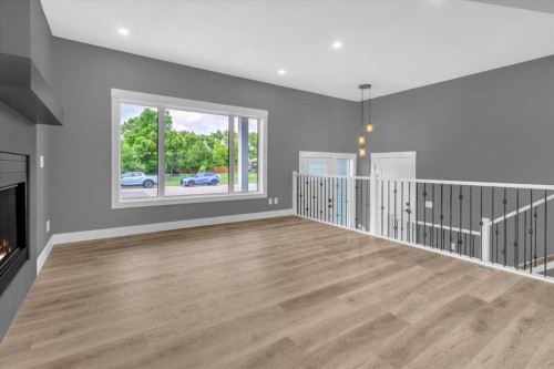 2016 30 Avenue, Nanton, AB - Indoor With Fireplace