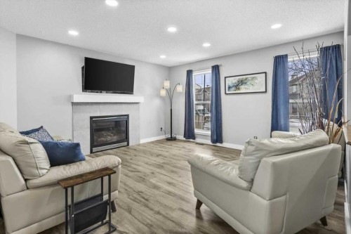 39 Prestwick Heath Se, Calgary, AB - Indoor Photo Showing Living Room With Fireplace