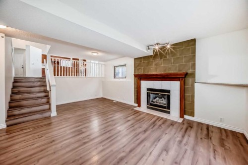 9875 Hidden Valley Drive Nw, Calgary, AB - Indoor Photo Showing Other Room With Fireplace