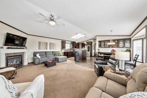 4 Spring Dale Circle Se, Airdrie, AB - Indoor Photo Showing Living Room With Fireplace