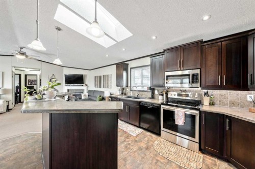 4 Spring Dale Circle Se, Airdrie, AB - Indoor Photo Showing Kitchen With Double Sink With Upgraded Kitchen
