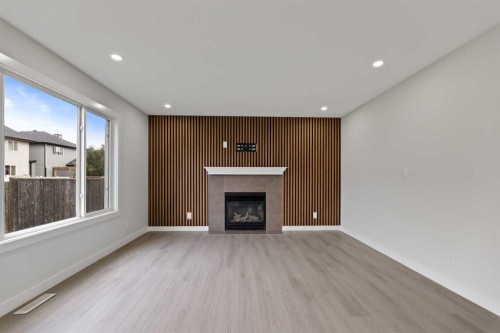 81 Saddlecrest Green Ne, Calgary, AB - Indoor Photo Showing Living Room With Fireplace