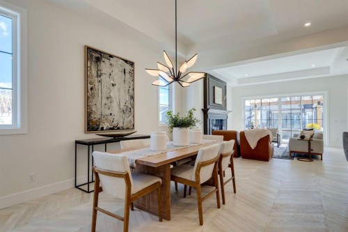 11 Normandy Lane Sw, Calgary, AB - Indoor Photo Showing Dining Room With Fireplace