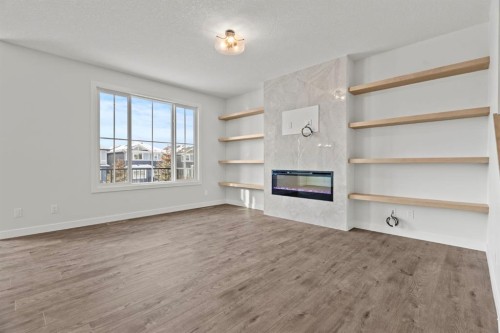 2220 Lancaster Heights Se, Airdrie, AB - Indoor Photo Showing Other Room With Fireplace