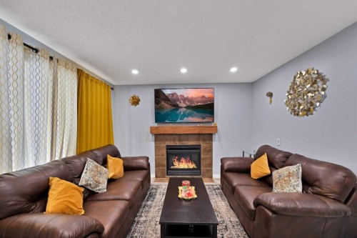 67 Copperstone Circle Se, Calgary, AB - Indoor Photo Showing Living Room With Fireplace