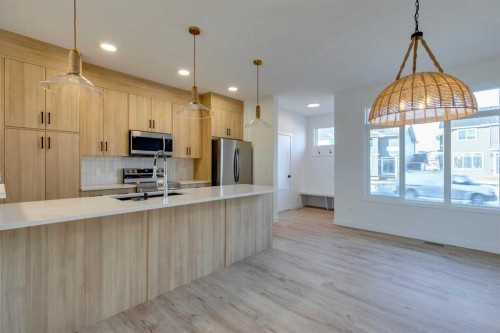 98 Agate Road, Cochrane, AB - Indoor Photo Showing Kitchen With Upgraded Kitchen