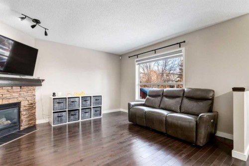 815 Tuscany Drive Nw, Calgary, AB - Indoor Photo Showing Living Room With Fireplace