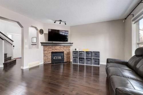 815 Tuscany Drive Nw, Calgary, AB - Indoor Photo Showing Living Room With Fireplace