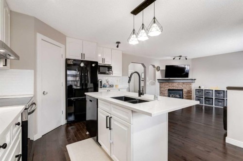 815 Tuscany Drive Nw, Calgary, AB - Indoor Photo Showing Kitchen With Fireplace With Double Sink