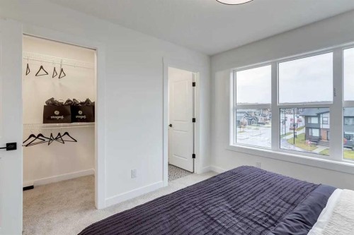 1507-525 River Heights Drive, Cochrane, AB - Indoor Photo Showing Bedroom