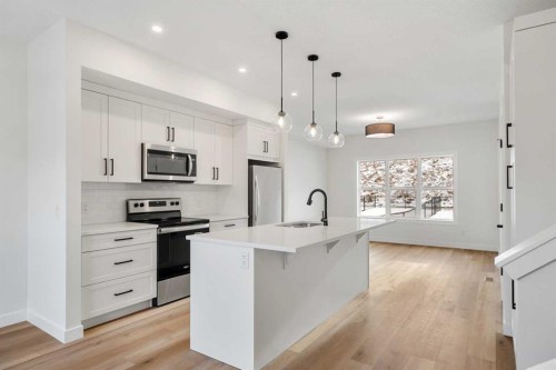 804-525 River Heights Drive, Cochrane, AB - Indoor Photo Showing Kitchen With Stainless Steel Kitchen With Upgraded Kitchen
