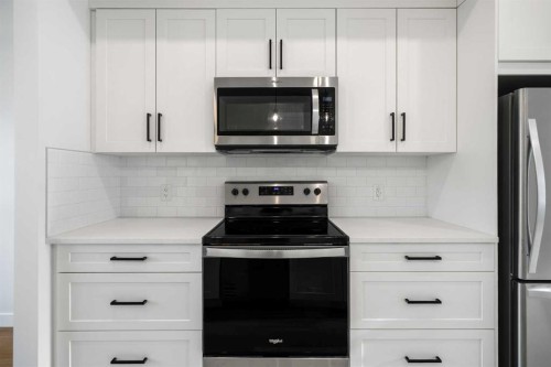 804-525 River Heights Drive, Cochrane, AB - Indoor Photo Showing Kitchen With Stainless Steel Kitchen With Upgraded Kitchen