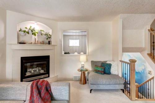 105 Inglewood Grove Se, Calgary, AB - Indoor Photo Showing Living Room With Fireplace