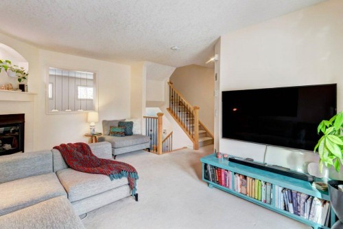 105 Inglewood Grove Se, Calgary, AB - Indoor Photo Showing Living Room With Fireplace