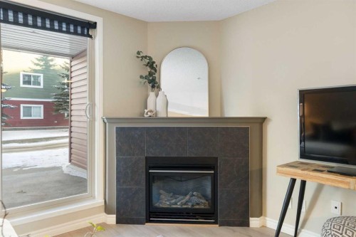 4104-10 Prestwick Bay Se, Calgary, AB - Indoor Photo Showing Living Room With Fireplace