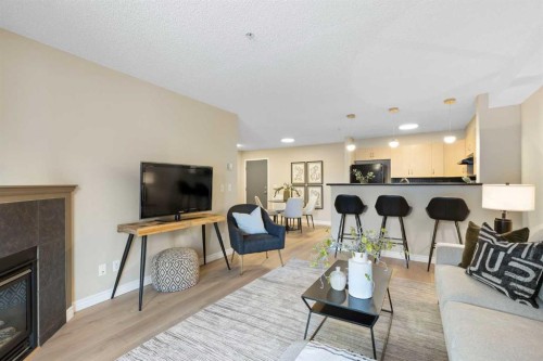 4104-10 Prestwick Bay Se, Calgary, AB - Indoor Photo Showing Living Room With Fireplace