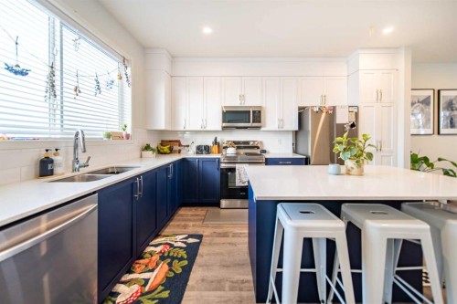 27 Iris Crescent, Okotoks, AB - Indoor Photo Showing Kitchen With Stainless Steel Kitchen With Double Sink With Upgraded Kitchen